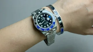 Close-up of Batman GMT Steel Bracelet watch with black and blue bezel on a man's wrist, premium titanium steel bracelet
