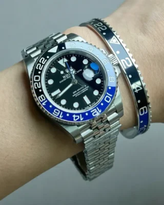 Close-up of Batman GMT Steel Bracelet watch with black and blue bezel on a man's wrist, premium titanium steel bracelet