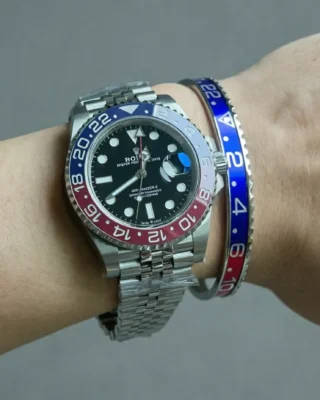 Close-up of Pepsi GMT Steel Bracelet watch with classic red and blue bezel on a man's wrist, premium titanium steel bracelet