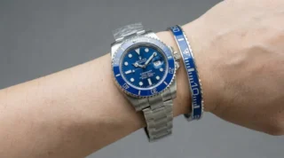 Close-up of Smurf Blue Submariner Steel Bracelet watch with iconic blue dial and bezel on a man's wrist, premium titanium steel bracelet