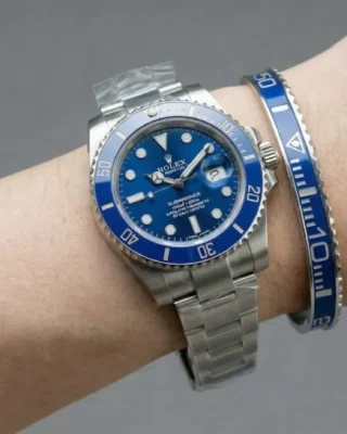 Close-up of Smurf Blue Submariner Steel Bracelet watch with iconic blue dial and bezel on a man's wrist, premium titanium steel bracelet