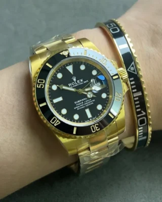 Close-up of Submariner Black Dial 116618LN watch with premium gold tone bracelet