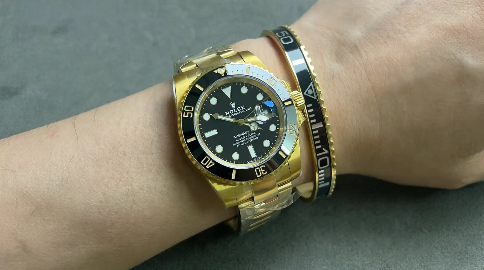 Close-up of Submariner Black Dial 116618LN watch with premium gold tone bracelet