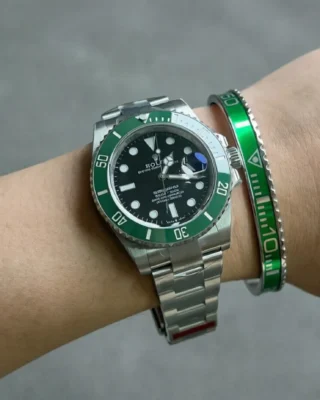 Close-up of Starbucks Green Submariner watch with vibrant green dial and bezel on a man's wrist, premium titanium steel bracelet