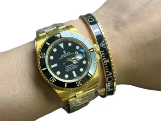Black Gold Submariner Gold Tone Titanium Steel Bracelet on wrist with two-tone Rolex Submariner watch
