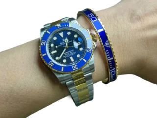 Blue Submariner Gold Tone Titanium Steel Bracelet worn on wrist with two-tone Rolex Submariner watch