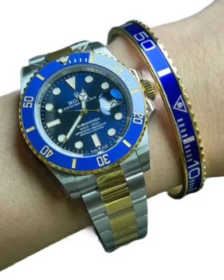 Blue Submariner Gold Tone Titanium Steel Bracelet worn on wrist with two-tone Rolex Submariner watch