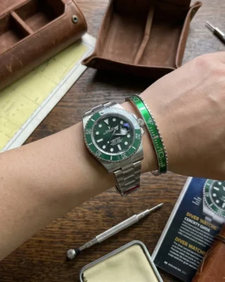 Close-up of a wrist wearing a sleek Green Submariner Titanium Steel Bracelet perfectly paired with a Rolex Submariner watch.