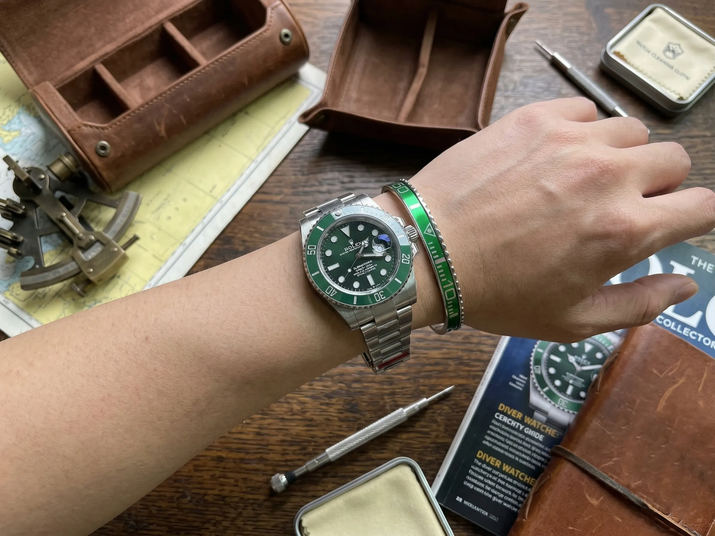 Close-up of a wrist wearing a sleek Green Submariner Titanium Steel Bracelet perfectly paired with a Rolex Submariner watch.