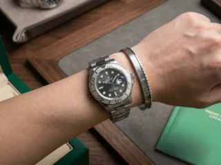 Close-up of a wrist wearing a sleek Silver Yacht-Master Titanium Steel Bracelet perfectly paired with a Rolex Yacht-Master watch.