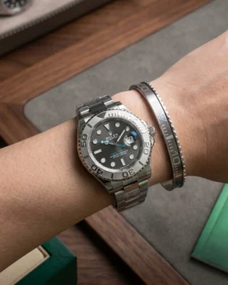 Close-up of a wrist wearing a sleek Silver Yacht-Master Titanium Steel Bracelet perfectly paired with a Rolex Yacht-Master watch.