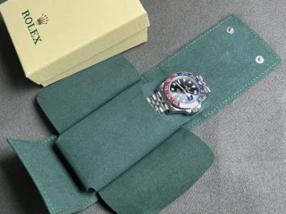 Rolex GMT Master II Pepsi Replica placed inside premium green watch travel pouch