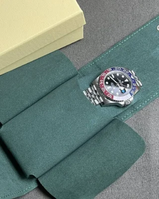Rolex GMT Master II Pepsi Replica placed inside premium green watch travel pouch