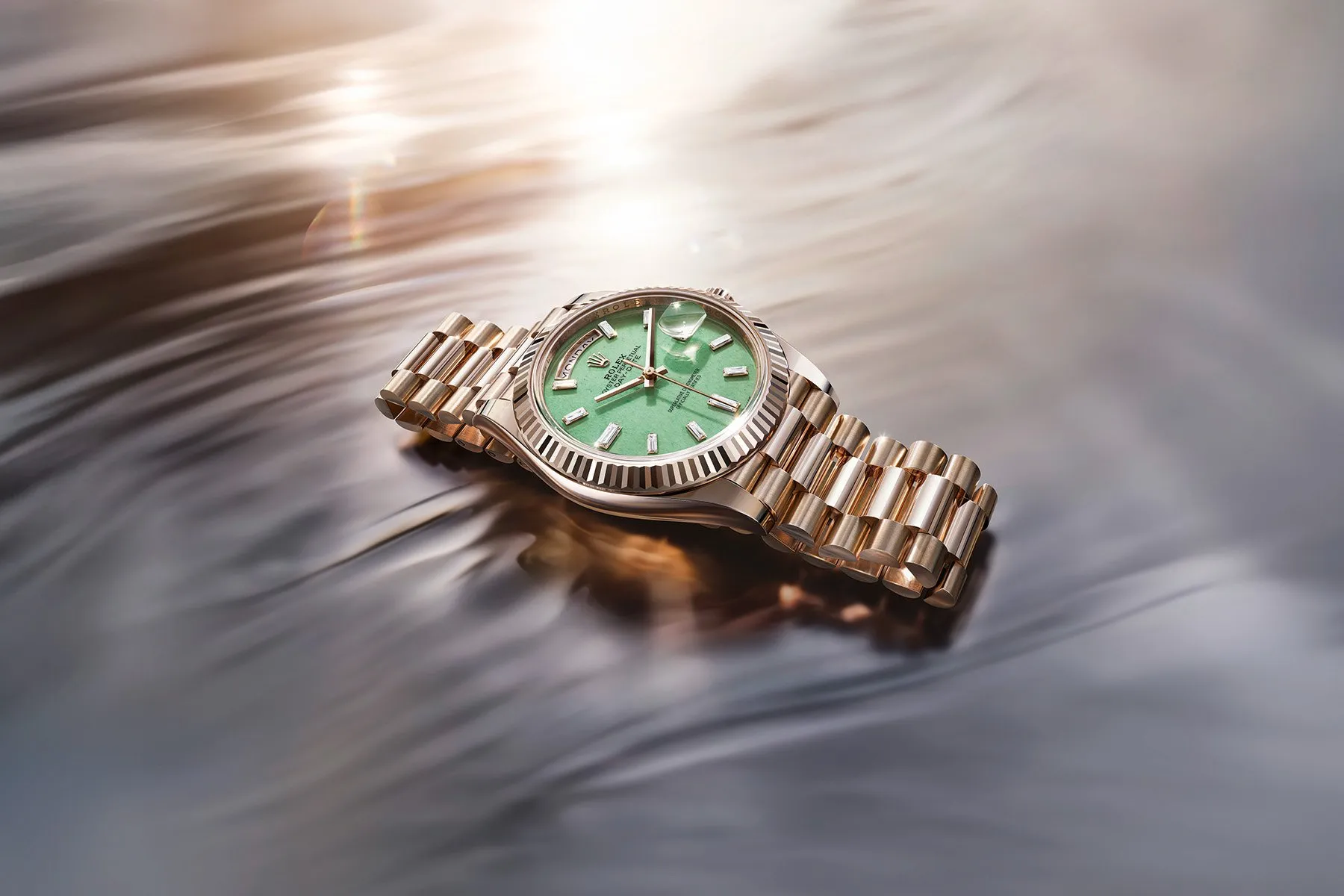 Rolex Day-Date 40 Jubilee Gold and Aventurine Dial on a water background